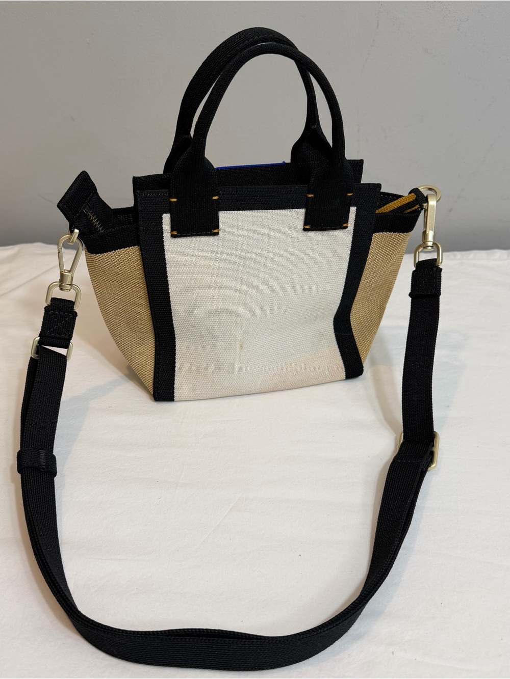 Rothy's The Mini Handbag in the ivory, black, and light camel "Piano Keys"